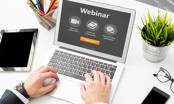 The webinar word is showing on laptop screen
