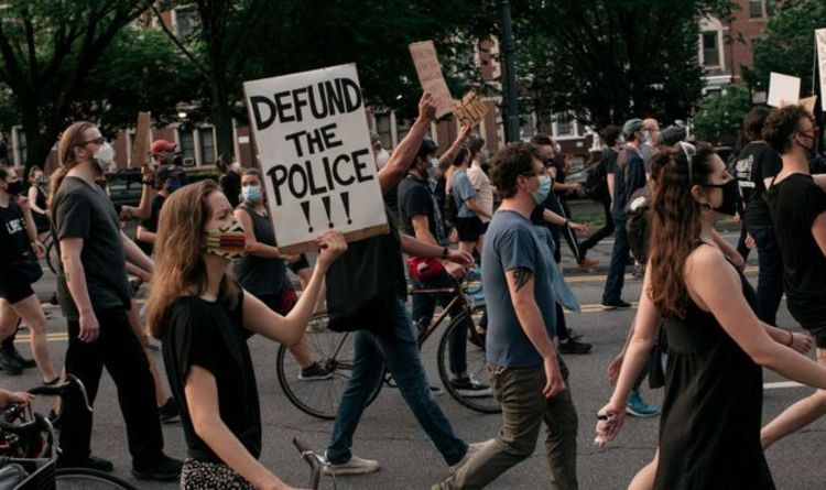 People are protesting at a rally on the road