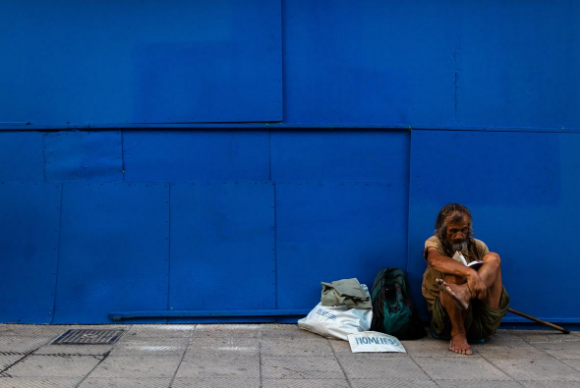 A beggar is sitting