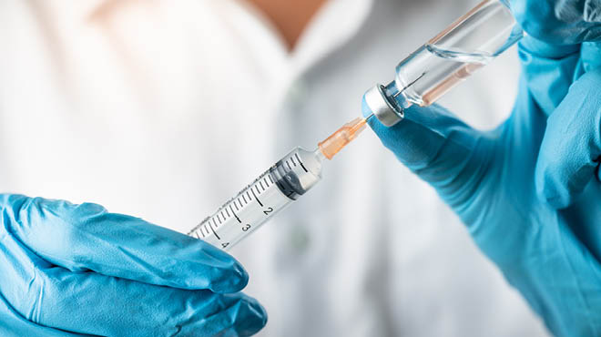 injecting the vaccine into the injection