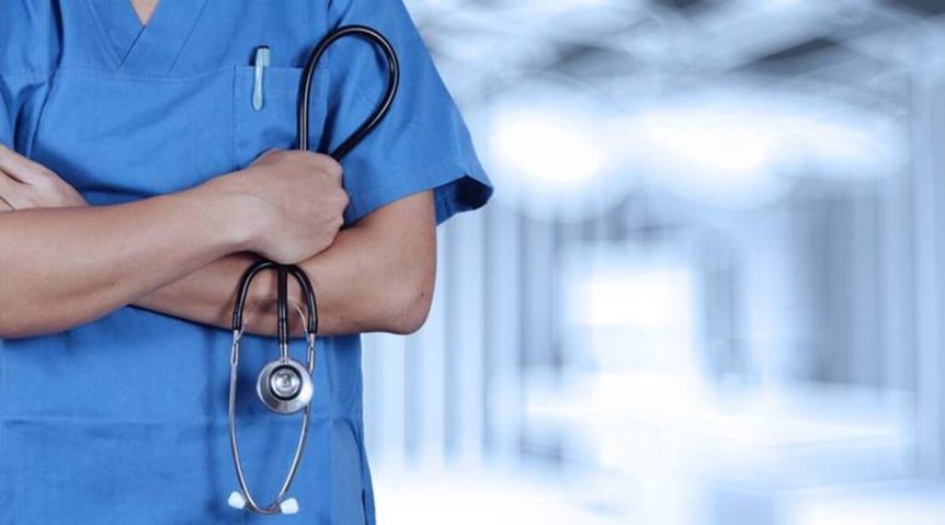 A doctor holds a stetoscope in hand