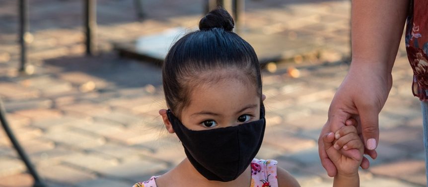 A kid is wearing a mask