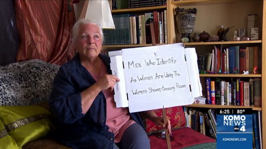 A women is holding a placard in her hand