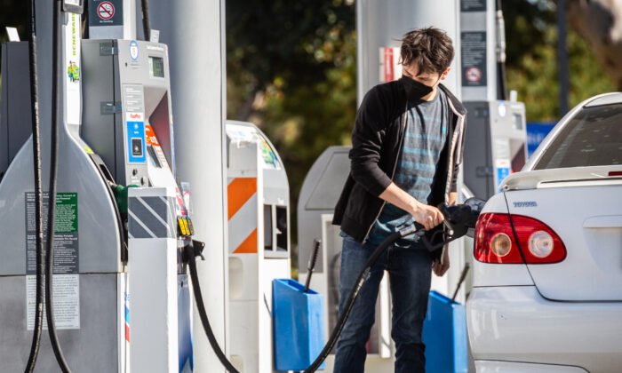 A man is refueling his car