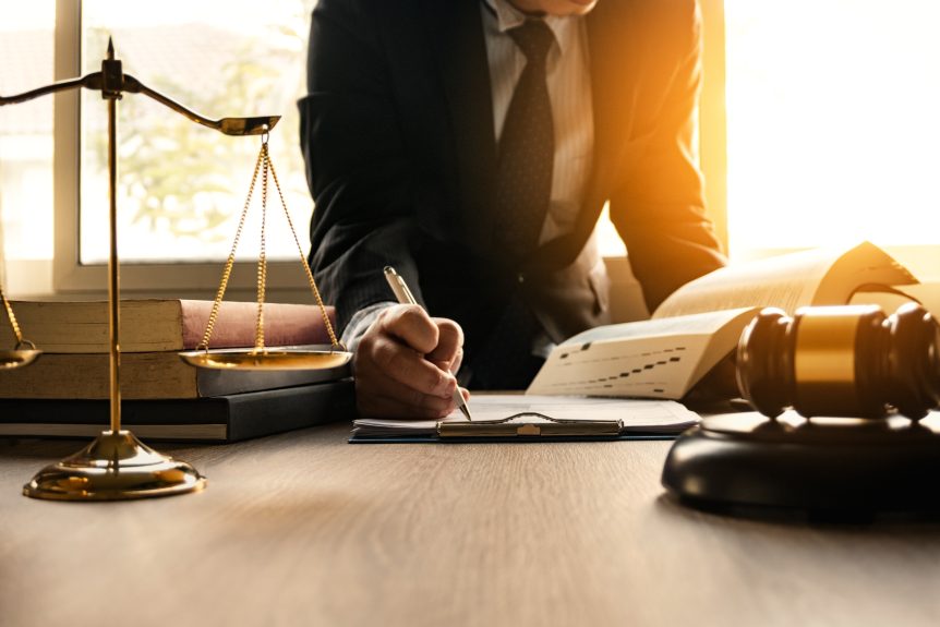 A lawyer is writing on paper