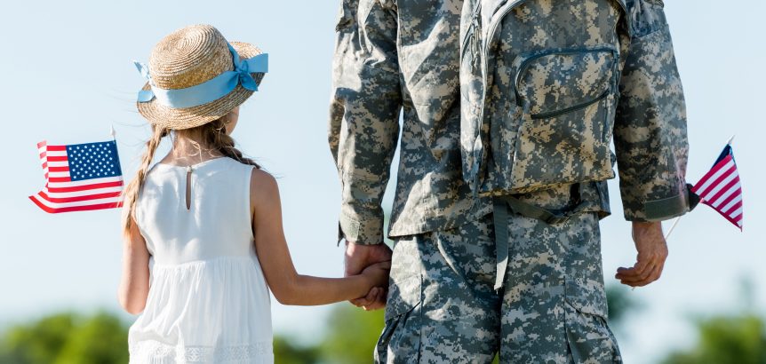 An army person is standing with his kid