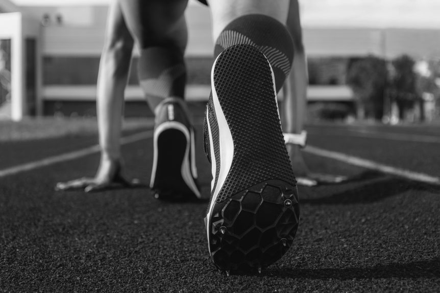 A person willing to start a sprint on a running track
